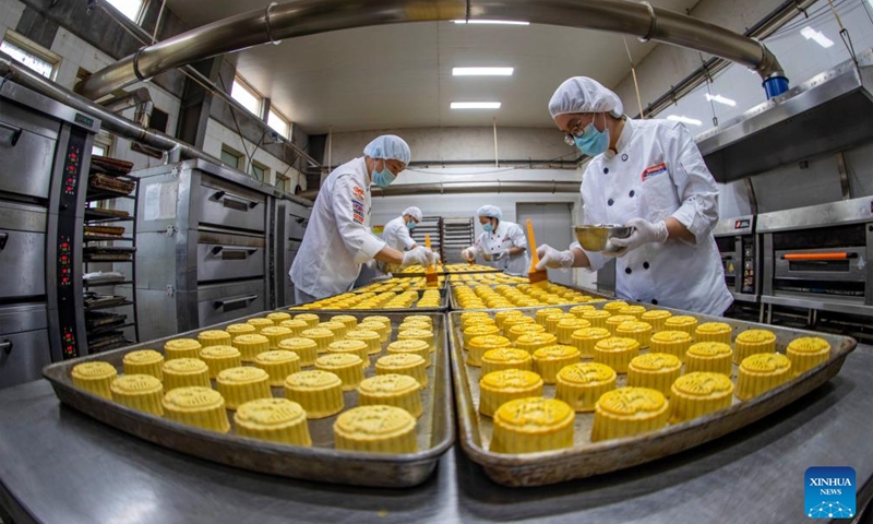 Workers make moon cakes at a workshop in Taizhou City, east China's Jiangsu Province, Sept. 13, 2023. This year's Mid-Autumn Festival falls on Sept. 2 (Photo: Xinhua)