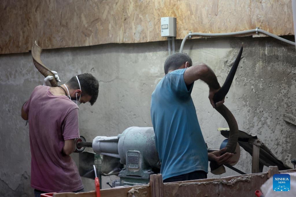 Workers make shofars at a factory in Tel Aviv, Israel, on Sept. 10, 2023. Jews blow the traditional shofar or ram's horn while praying in synagogues during the holiday of Rosh Hashanah, the Jewish New Year.(Photo: Xinhua)