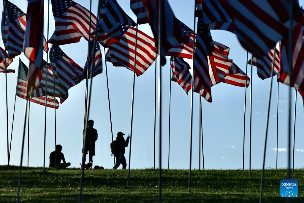 People are seen among the Waves of Flags at Pepperdine University in Malibu, California, the United States, on Sept. 10, 2023. Each September, the university stages the Waves of Flags display to honor the victims of the 9/11 attacks.(Photo: Xinhua)