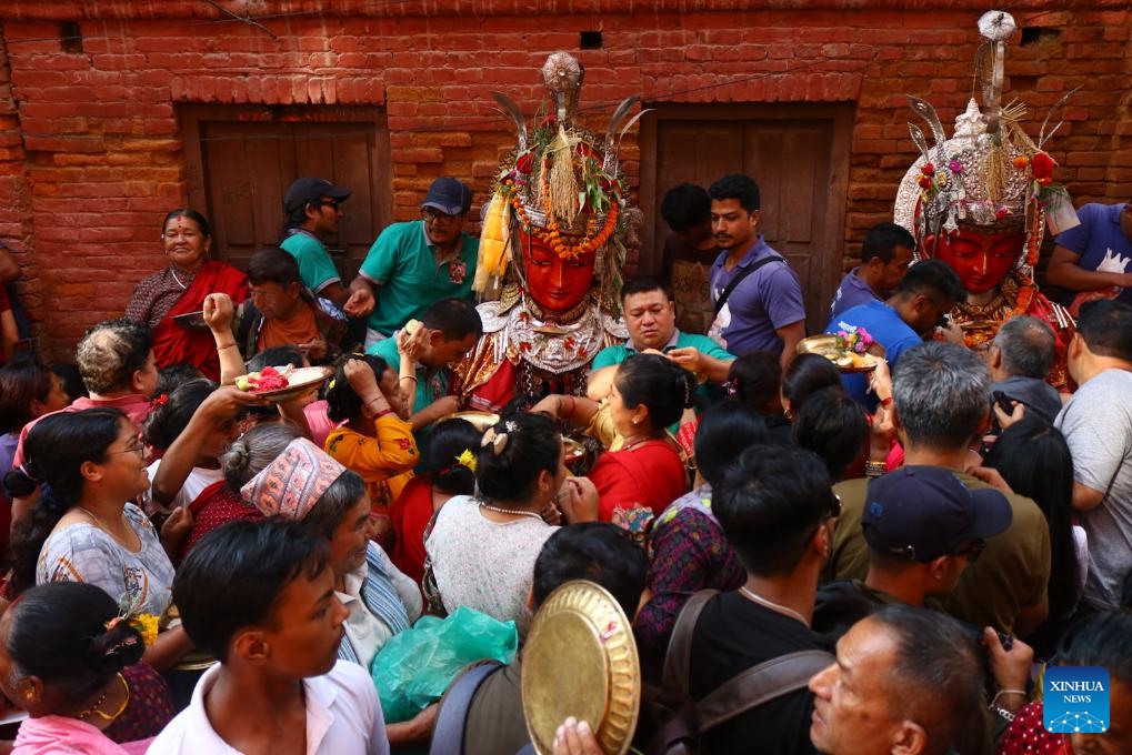 Devotees worship idols of Buddha during the Pancha Dan festival in Bhaktapur, Nepal, Sept. 12, 2023. Pancha Dan, the festival of five summer gifts, is observed by the Buddhists by giving away five elements, namely wheat grains, rice grains, salt, money and fruits(Photo: Xinhua)