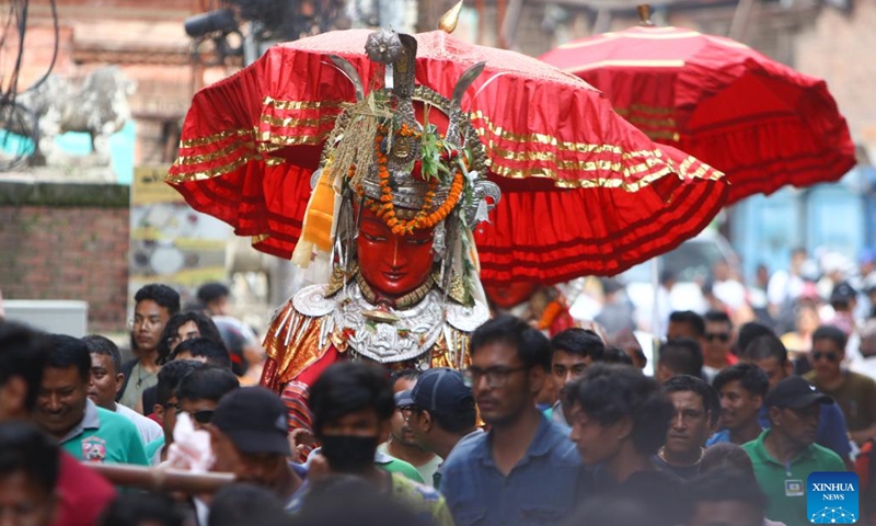 An idol of Buddha is seen during the Pancha Dan festival in Bhaktapur, Nepal, Sept. 12, 2023. Pancha Dan, the festival of five summer gifts, is observed by the Buddhists by giving away five elements, namely wheat grains, rice grains, salt, money and fruits.(Photo: Xinhua)