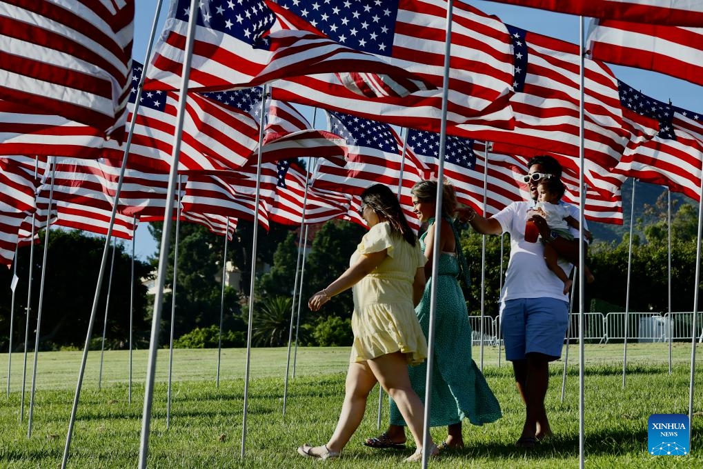 People walk among the Waves of Flags at Pepperdine University in Malibu, California, the United States, on Sept. 10, 2023. Each September, the university stages the Waves of Flags display to honor the victims of the 9/11 attacks.(Photo: Xinhua)