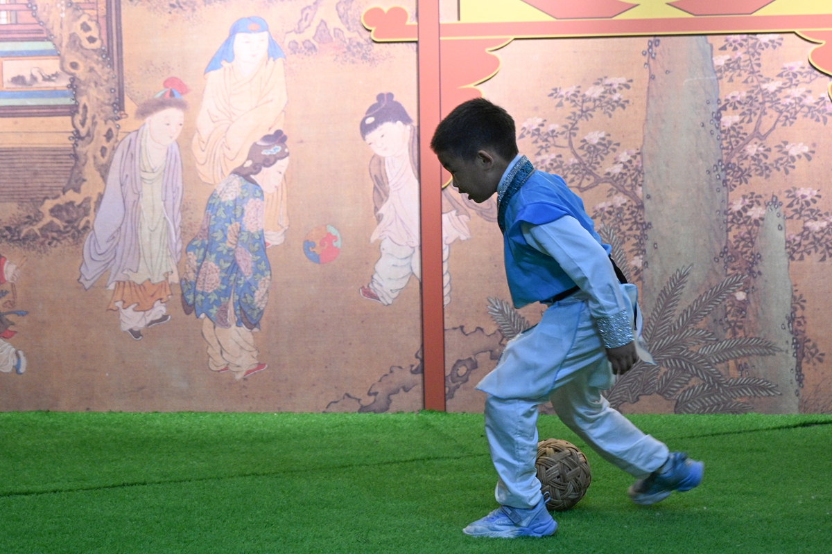 A kid plays cuju during an exhibition for kids to experience Song Dynasty (960-1279) sports at the China Silk Museum in Hangzhou, East China's Zhejiang Province, the host city of the upcoming 19th Asian Games, on September 14, 2023. Cuju is a type of ancient Chinese football enjoyed by ordinary people as far back as 2,400 years ago. Photo: VCG 