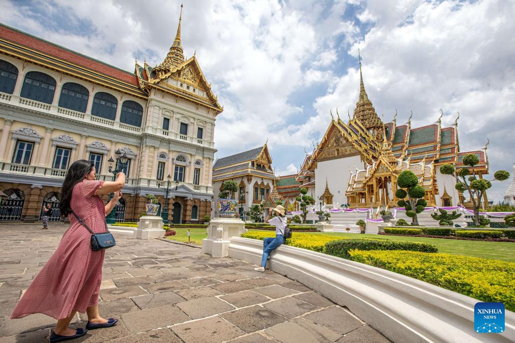 Tourists take photos at the Grand Palace scenic spot in Bangkok, Thailand, June 15, 2023. Thailand has approved a temporary visa waiver for visitors from China and Kazakhstan during the year-end high season in support of its vital tourism industry.(Photo: Xinhua)