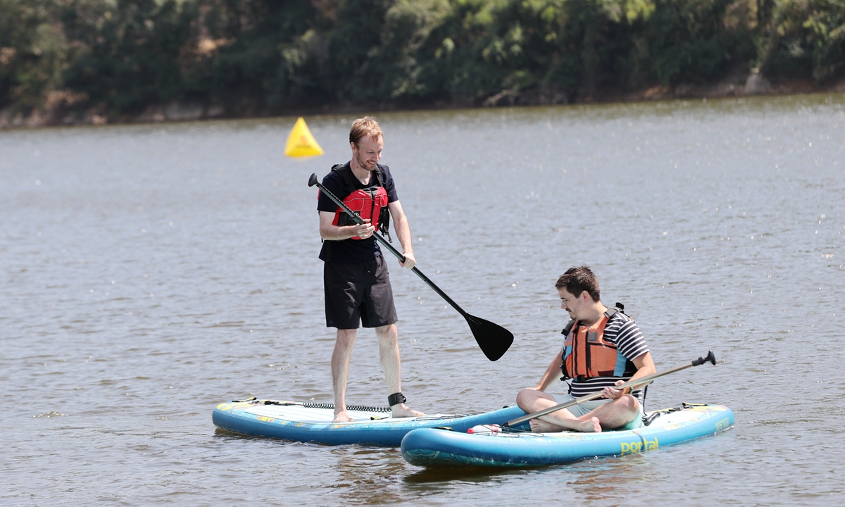 Foreign tourists experience paddleboarding at Elephant & Moon Resort in Deqing county, Zhejiang Province. Photo: Xie Shangguo