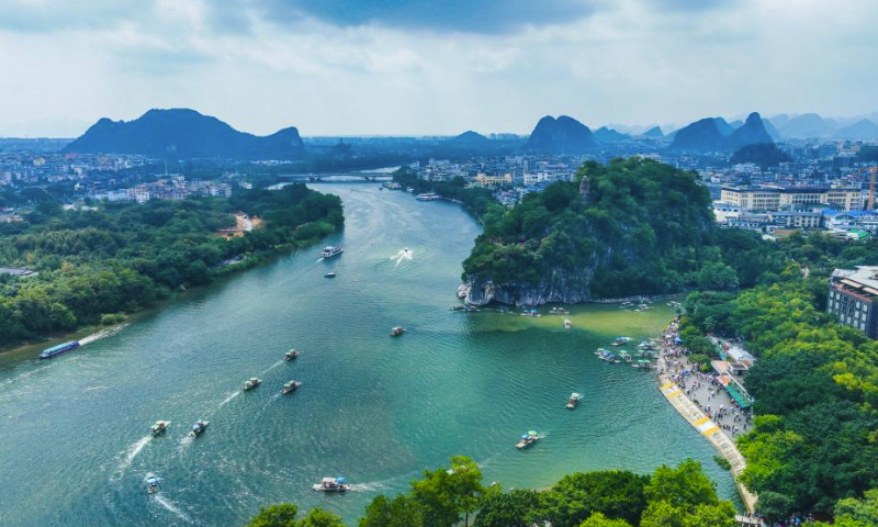 This aerial photo taken on Oct. 3, 2023 shows tourists taking boats on Lijiang River in Guilin City, south China's Guangxi Zhuang Autonomous Region.

The Mid-Autumn Festival and National Day holiday period, which lasts from Sept. 29 to Oct. 6 this year, is a peak travel and tourism season in China. (Photo by Liu Zheng/Xinhua)