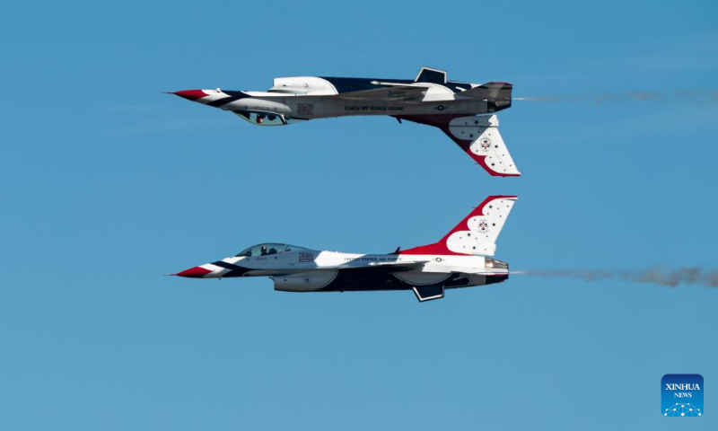 Two F-16 Fighting Falcon aircraft from the U.S. Air Force Thunderbirds perform during the airshow at Ellington Airport, Houston, Texas, the United States, on Oct. 14, 2023. The annual Wings Over Houston Airshow is held from Oct. 14 to 15. (Photo by Chen Chen/Xinhua)