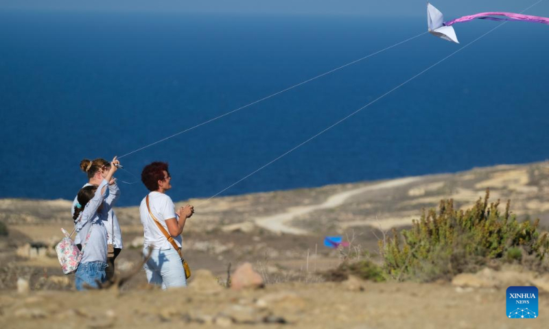 People take part in the 6th edition of the International Kite and Wind Festival in the village of Gharb on the island of Gozo, Malta, on Oct. 15, 2023. (Photo by Jonathan Borg/Xinhua)