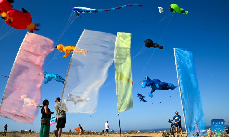 People take part in the 6th edition of the International Kite and Wind Festival in the village of Gharb on the island of Gozo, Malta, on Oct. 15, 2023. (Photo by Jonathan Borg/Xinhua)