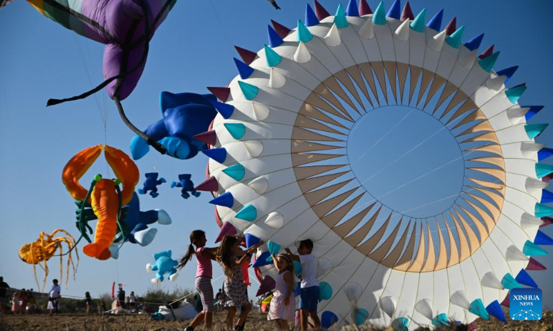 People take part in the 6th edition of the International Kite and Wind Festival in the village of Gharb on the island of Gozo, Malta, on Oct. 15, 2023. (Photo by Jonathan Borg/Xinhua)