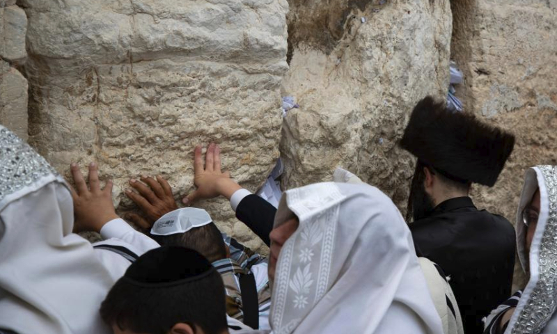 Jewish worshippers attend the Priestly Blessing during Sukkot at the Western Wall in the Old City of Jerusalem, on Oct. 4, 2023. The Sukkot, or Feast of Tabernacles, falling from sunset of Sept. 29 to sunset of Oct. 6 this year, is a biblical week-long holiday that recollects the 40 years of travel in the desert after the Exodus from slavery in Egypt. (Xinhua/Chen Junqing)