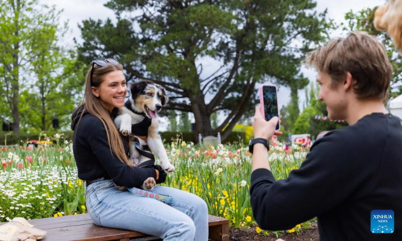 A woman poses for photos with her dog at 