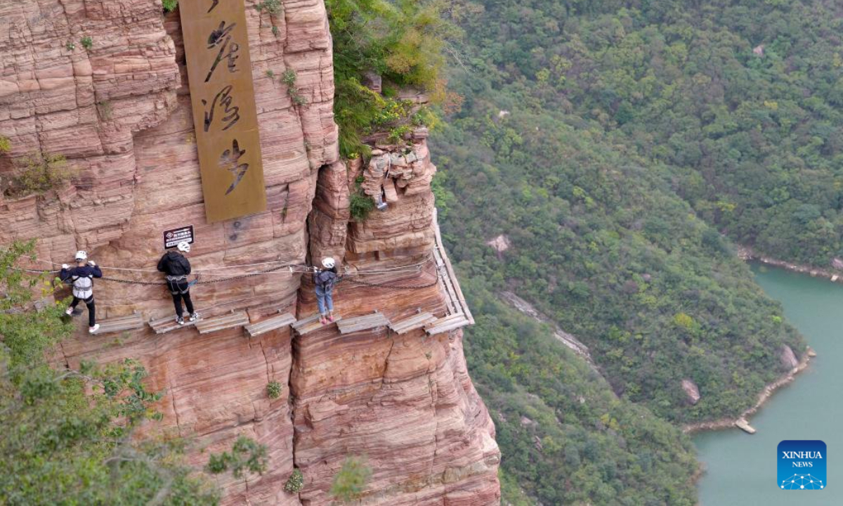 Tourists have fun at the Baoquan scenic spot in Huixian, central China's Henan Province, on Oct 19, 2023. Photo:Xinhua