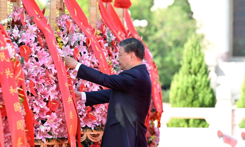 Xi Jinping straightens the ribbon on a flower basket during a ceremony to present flower baskets to fallen national heroes in Tian'anmen Square in Beijing, capital of China, Sept. 30, 2023. Xi Jinping and other leaders of the Communist Party of China and the state including Li Qiang, Zhao Leji, Wang Huning, Cai Qi, Ding Xuexiang, Li Xi and Han Zheng attended a ceremony on Saturday morning in Beijing to present flower baskets to fallen national heroes. The event was held to mark China's 10th Martyrs' Day, a day ahead of its National Day. (Xinhua/Yin Bogu)