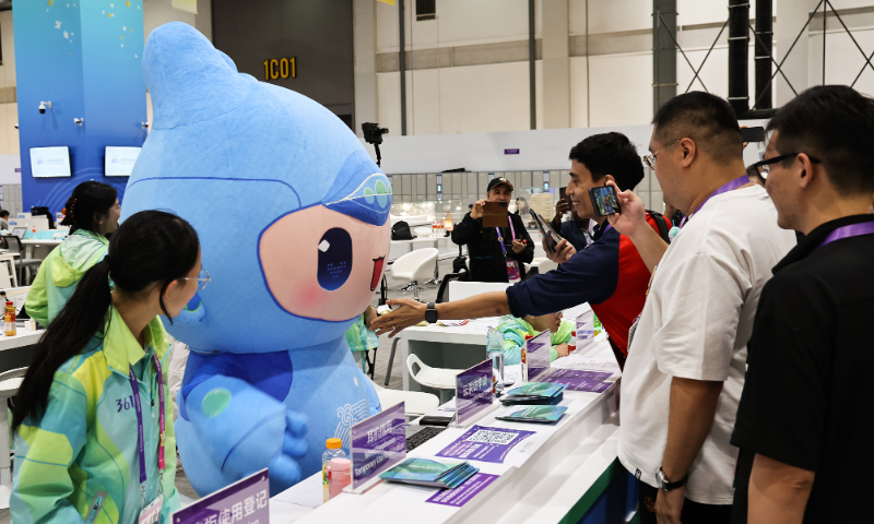 Reporters take photos for Chenchen, one of the mascots of the Hangzhou Asian Games at the Main Media Center on September 22, 2023 in Hangzhou. Photo: VCG