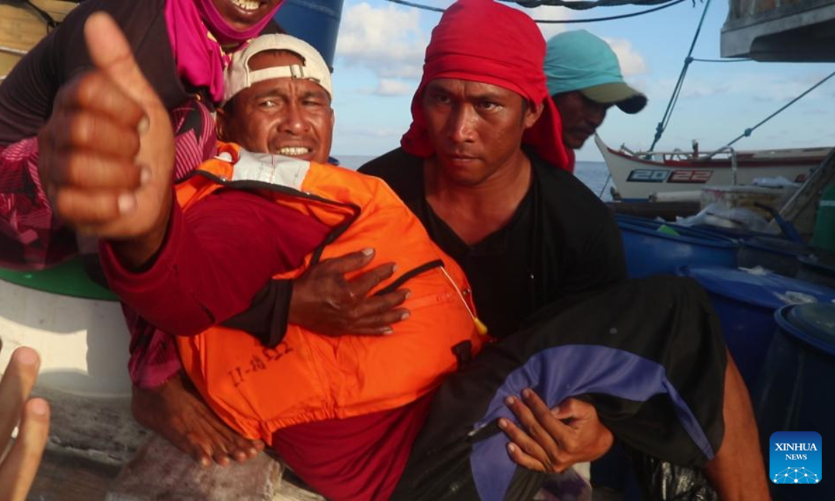 A Philippine fisherman gestures after being rescued by soldiers of the Chinese People's Liberation Army (PLA) naval vessel Aba. Photo:Xinhua