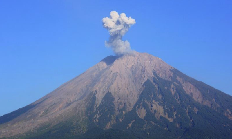 This photo taken on Oct. 1, 2023 shows volcanic materials spewing from Mount Semeru, as seen from Lumajang, East Java, Indonesia. (Photo by Dwi Sasongko/Xinhua)