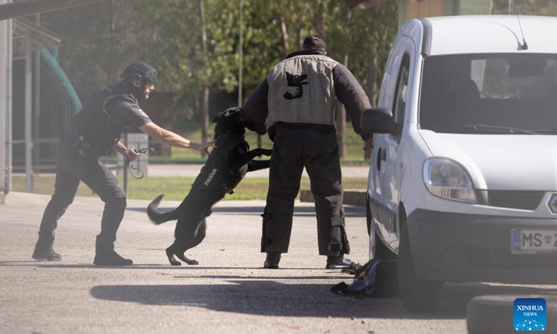 A police dog handler demonstrates his skills during the SOBRA international fair in Gornja Radgona, Slovenia, on Sept. 21, 2023. Slovenia will increase its defense budget, the country's Minister of Defense Marjan Sarec said at the biennial four-day SOBRA international fair focusing on the areas of defense, security, protection and rescue that opened on Thursday.(Photo: Xinhua)