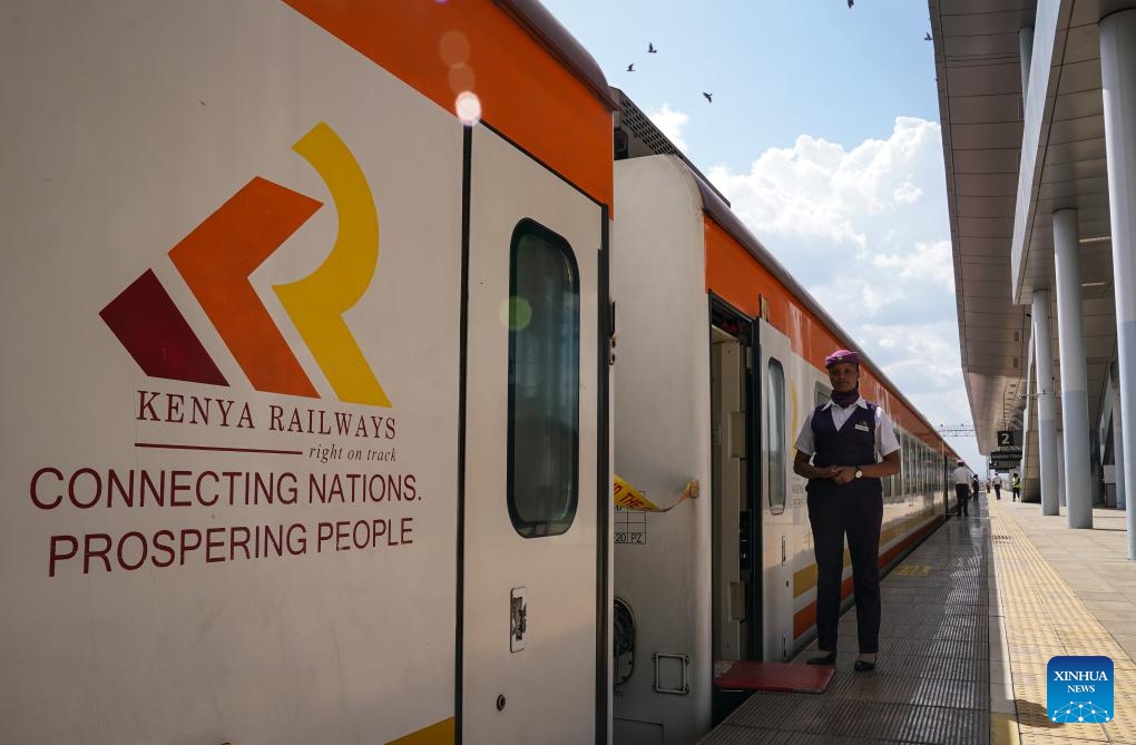 A stewardess stands next to the train to Mombasa at Nairobi Terminus Station of the China built Mombasa-Nairobi Standard Gauge Railway (SGR) in Nairobi, Kenya, Sept. 20, 2023. In 2017, the SGR, built and operated by China Road and Bridge Corporation, was officially opened to traffic. As the first railway built since Kenya's independence, it runs 480 km between the capital Nairobi and the port city of Mombasa.(Photo: Xinhua)