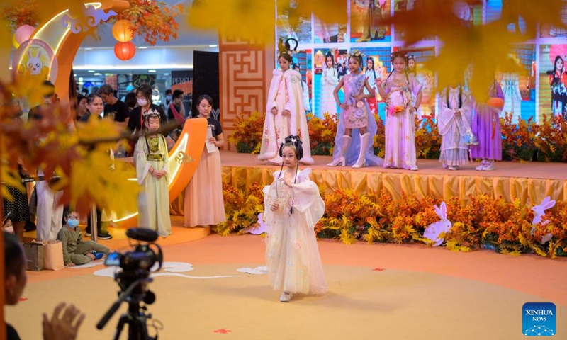 Children wearing Hanfu, an ancient clothing traditionally used to be worn by ethnic-majority Han Chinese, participate in an event to celebrate the upcoming Mid-Autumn Festival in Kuala Lumpur, Malaysia, Sept. 24, 2023. (Photo by Chong Voon Chung/Xinhua)