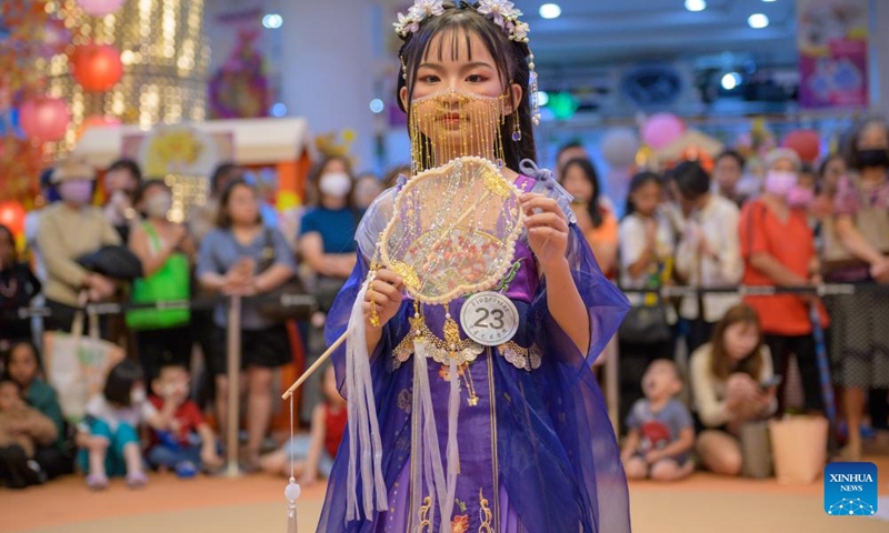 A girl wearing Hanfu, an ancient clothing traditionally used to be worn by ethnic-majority Han Chinese, participates in an event to celebrate the upcoming Mid-Autumn Festival in Kuala Lumpur, Malaysia, Sept. 24, 2023. (Photo by Chong Voon Chung/Xinhua)

