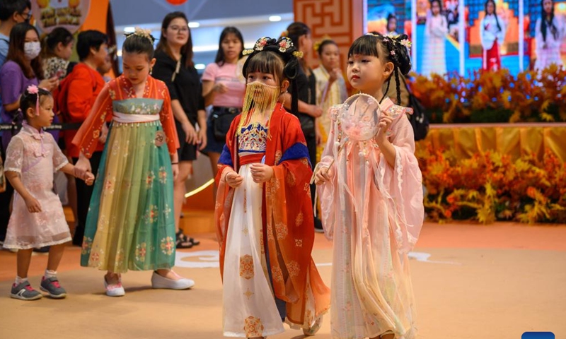 Children wearing Hanfu, an ancient clothing traditionally used to be worn by ethnic-majority Han Chinese, participate in an event to celebrate the upcoming Mid-Autumn Festival in Kuala Lumpur, Malaysia, Sept. 24, 2023. (Photo by Chong Voon Chung/Xinhua)