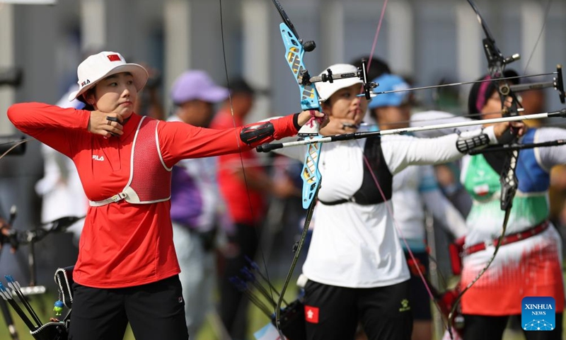 Hailigan (L) of China competes during the Recurve Mixed Team 1/8 Elimination of Archery between team China and team China's Hong Kong at the 19th Asian Games in Hangzhou, east China's Zhejiang Province, Oct. 2, 2023. (Xinhua/Meng Chenguang)