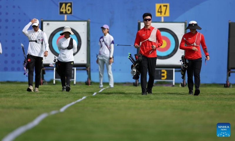 Wei Shaoxuan (2nd R)/Hailigan (1st R) of China and Kwok Yin Chai (1st L)/Poon Wei Tsing Natalie of China's Hong Kong compete during the Recurve Mixed Team 1/8 Elimination of Archery between team China and team China's Hong Kong at the 19th Asian Games in Hangzhou, east China's Zhejiang Province, Oct. 2, 2023. (Xinhua/Meng Chenguang)