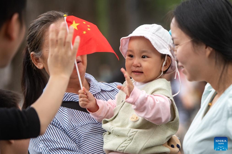 People visit Donghu Lake scenic spot in Wuhan, central China's Hubei Province, Oct. 1, 2023. People across the country enjoy themselves in various way on the first day of the National Day holiday. (Photo by Du Zixuan/Xinhua)