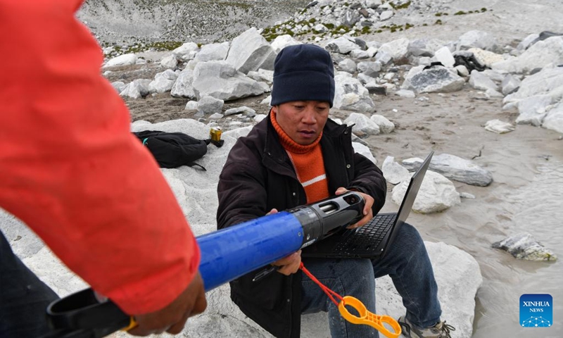 Members of a Chinese expedition team perform a real-time water quality check at a proglacial lake in the Mount Cho Oyu region on Oct. 1, 2023. An 18-member expedition team successfully reached on Sunday the summit of Mount Cho Oyu, also known as Mt. Qowowuyag, which soars to 8,201 meters above sea level, to carry out scientific research. It was the first time Chinese scientists scaled a peak exceeding 8,000 meters in altitude apart from Mt. Qomolangma, the world's highest summit.  Photo: Xinhua