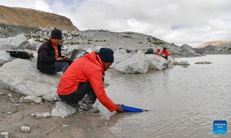 Members of a Chinese expedition team perform a real-time water quality check at a proglacial lake in the Mount Cho Oyu region on Oct. 1, 2023. An 18-member expedition team successfully reached on Sunday the summit of Mount Cho Oyu, also known as Mt. Qowowuyag, which soars to 8,201 meters above sea level, to carry out scientific research. It was the first time Chinese scientists scaled a peak exceeding 8,000 meters in altitude apart from Mt. Qomolangma, the world's highest summit.  Photo: Xinhua