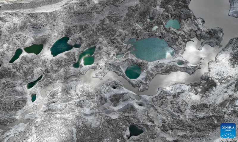 This aerial photo taken on Sept. 29, 2023 shows a proglacial lake in the Mount Cho Oyu region. An 18-member expedition team successfully reached on Sunday the summit of Mount Cho Oyu, also known as Mt. Qowowuyag, which soars to 8,201 meters above sea level, to carry out scientific research. It was the first time Chinese scientists scaled a peak exceeding 8,000 meters in altitude apart from Mt. Qomolangma, the world's highest summit. Photo: Xinhua