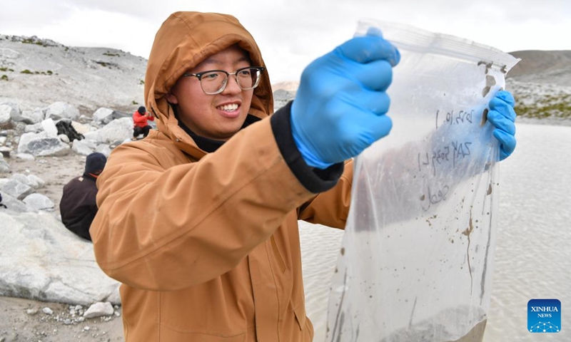 A member of a Chinese expedition team checks the samples collected from a proglacial lake in the Mount Cho Oyu region on Oct. 1, 2023. An 18-member expedition team successfully reached on Sunday the summit of Mount Cho Oyu, also known as Mt. Qowowuyag, which soars to 8,201 meters above sea level, to carry out scientific research. It was the first time Chinese scientists scaled a peak exceeding 8,000 meters in altitude apart from Mt. Qomolangma, the world's highest summit.  Photo: Xinhua