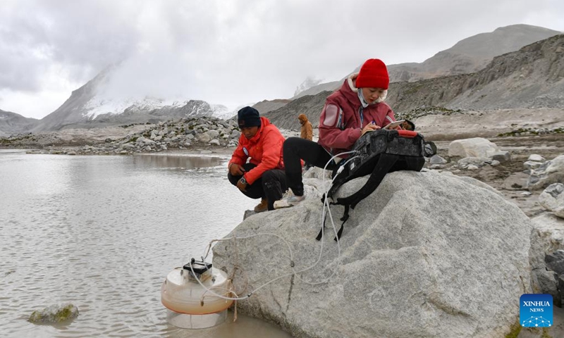 Members of a Chinese expedition team perform a real-time water quality check at a proglacial lake in the Mount Cho Oyu region on Oct. 1, 2023. An 18-member expedition team successfully reached on Sunday the summit of Mount Cho Oyu, also known as Mt. Qowowuyag, which soars to 8,201 meters above sea level, to carry out scientific research. It was the first time Chinese scientists scaled a peak exceeding 8,000 meters in altitude apart from Mt. Qomolangma, the world's highest summit. Photo: Xinhua