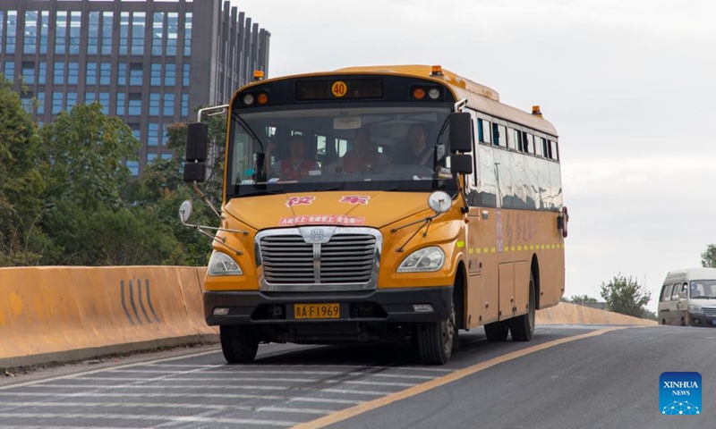 A school bus runs on a road at Guanshanhu District in Guiyang, southwest China's Guizhou Province, Sept. 7, 2023. (Xinhua)