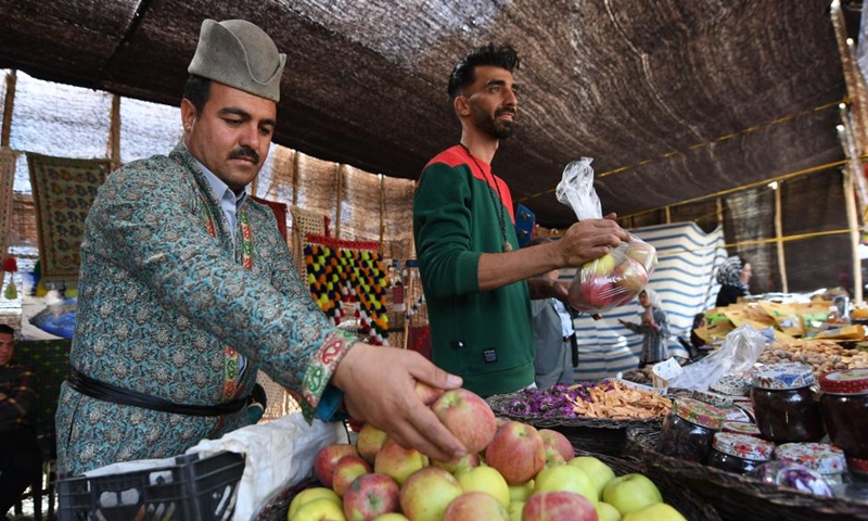 People sell goods in Tehran, Iran, Oct. 5, 2023. People from all parts of the country gathered here to exhibit and sell traditional products. (Xinhua/Shadati)