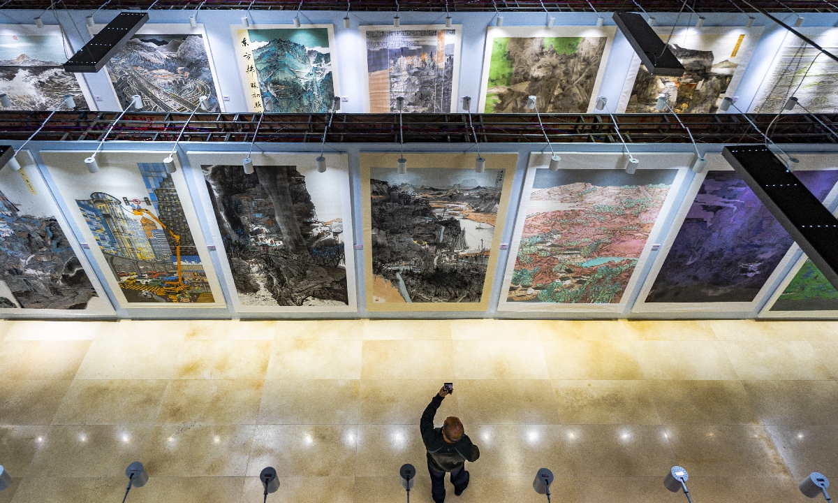 A visitor explores a painting exhibition in Xinyu, East China's Jiangxi Province, on October 9, 2023. A total of 198 works depicting the magnificent rivers and mountains of the country are on display. Photo: VCG