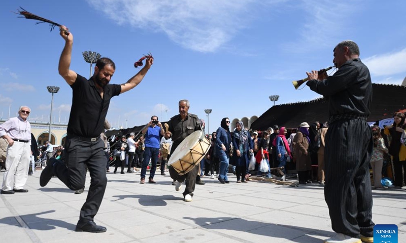 People dance at an event in Tehran, Iran, Oct. 5, 2023. People from all parts of the country gathered here to exhibit and sell traditional products. (Xinhua/Shadati)