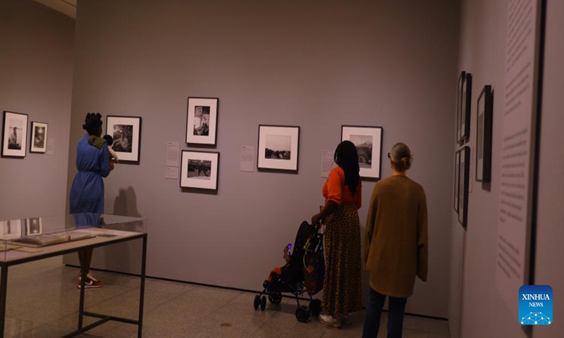 People attend the preview of a photo exhibition titled Robert Frank and Todd Webb: Across America, 1955 at the Museum of Fine Arts, Houston, Texas, the United States, on Oct. 6. 2023. A total of 100 photographs chart the cross-country journeys of two photographers, who each captured singular views of America in the mid-20th century, during the exhibition here from Oct. 8, 2023 to Jan. 7, 2024. (Xinhua/Xu Jianmei)