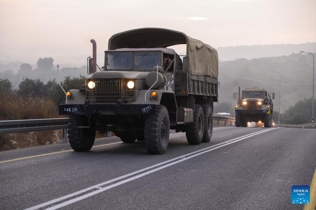 Israeli military vehicles ride on a road in northern Israel near the border with Lebanon on Oct. 8, 2023. Dozens of rockets and heavy artillery shells were fired toward Israeli positions on the Shebaa Farms, a disputed strip of land at the intersection of the Lebanese-Syrian border and the Israeli-annexed Golan Heights, early Sunday morning, Lebanese army intelligence sources confirmed to Xinhua.(Photo: Xinhua)