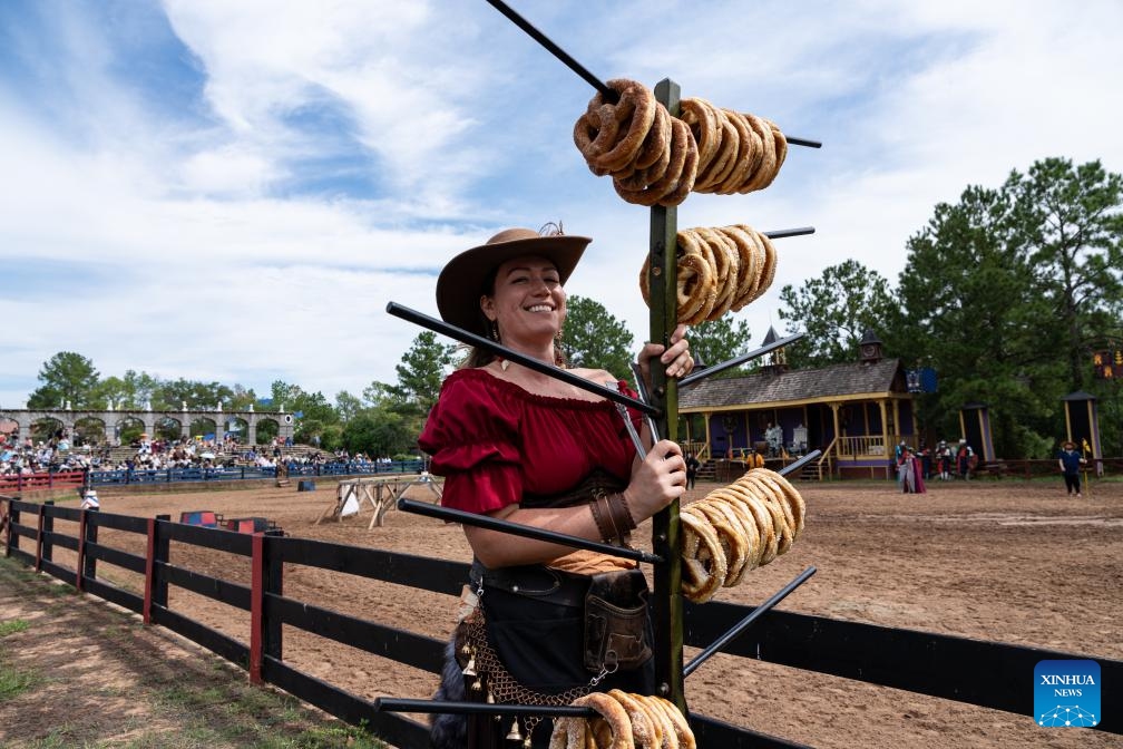 A vendor sells pretzels during Texas Renaissance Festival in Todd Mission, Texas, the United States, Oct. 7, 2023. Texas Renaissance Festival kicked off in the western U.S. state of Texas on Saturday, bringing the magic of the Renaissance time to life through Nov. 26(Photo: Xinhua)