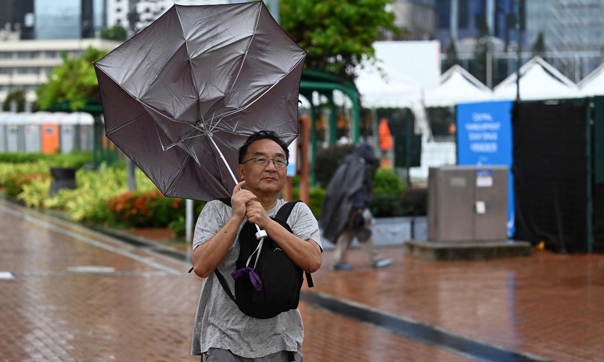 A man has his umbrella turned inside out as the Hong Kong Special Administrative Region issued a No.9 alert as a stronger-than-expected Typhoon Koinu pummeled the city on October 8, 2023. Photo: VCG 