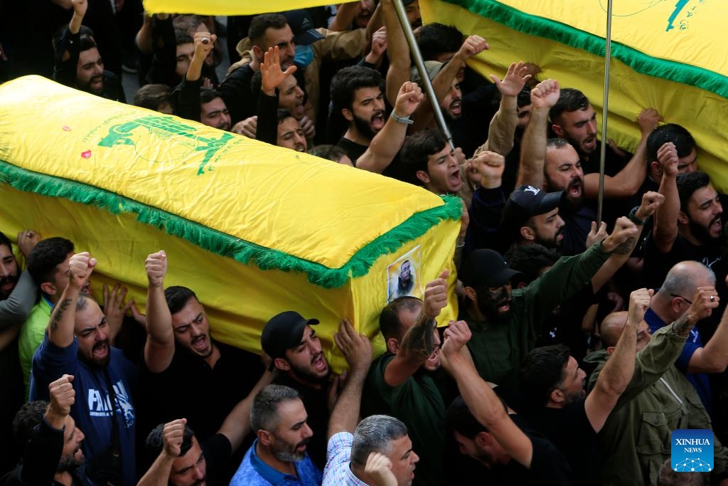 People carry a casket of a Hezbollah member killed in Israeli strikes during a funeral in the town of Khirbet Selm, southern Lebanon, on Oct. 10, 2023.(Photo: Xinhua)