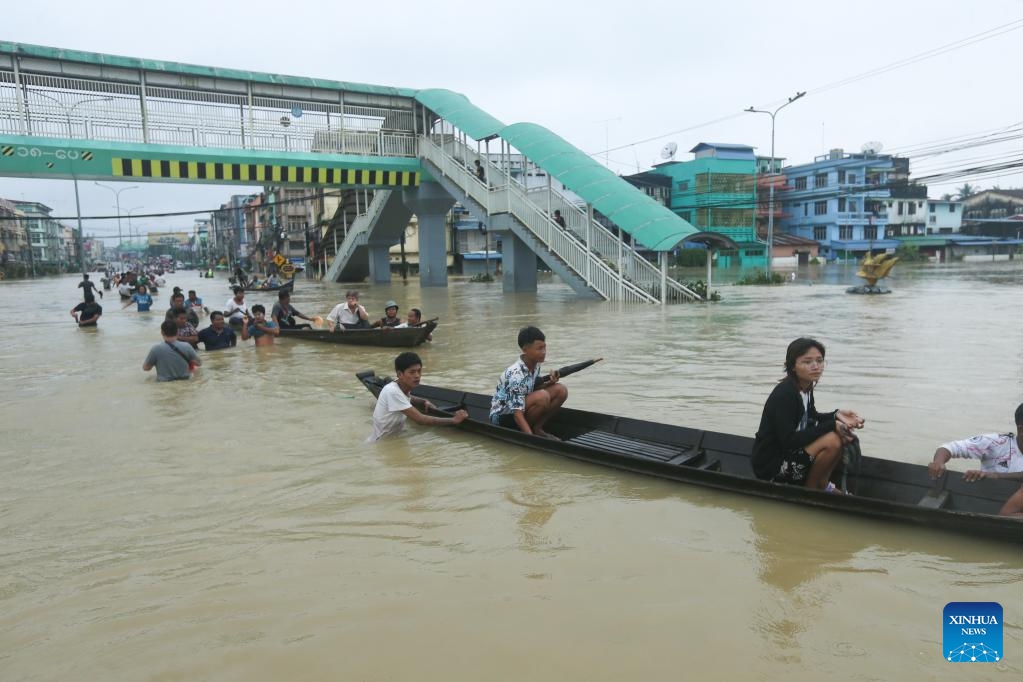 People take boats at a flooded area in Bago Region of southern Myanmar, Oct. 10, 2023. Heavy rainfall hit Bago on Sunday.(Photo: Xinhua)