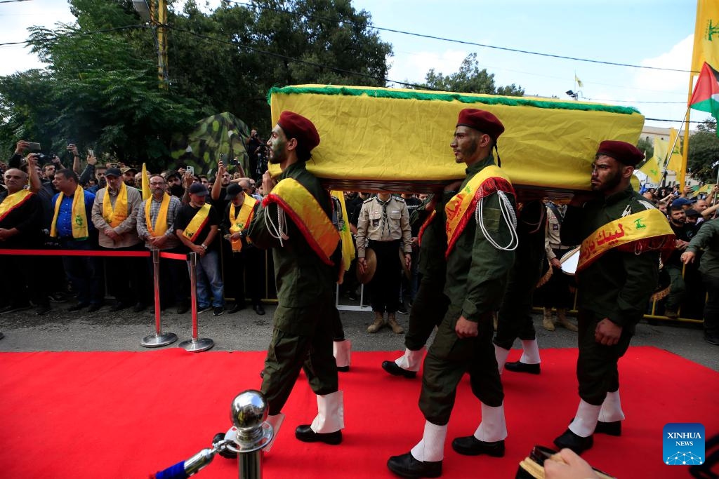 People carry a casket of a Hezbollah member killed in Israeli strikes during a funeral in the town of Khirbet Selm, southern Lebanon, on Oct. 10, 2023.(Photo: Xinhua)