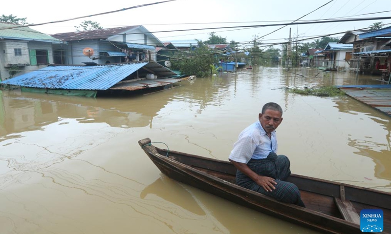 A man takes a boat at a flooded area in Bago, Myanmar, Oct. 9, 2023. Heavy rainfall hit Bago Region of southern Myanmar on Sunday, displacing thousands and disrupting rail traffic, local authorities said on Monday.(Photo: Xinhua)