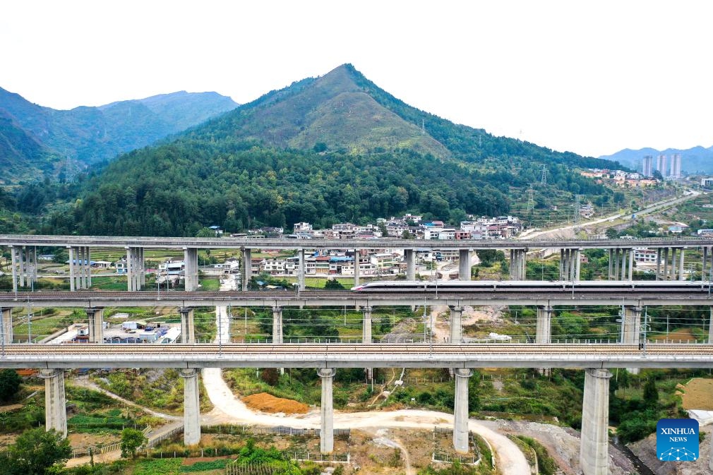 This aerial photo taken on Oct. 10, 2023 shows a bullet train running on a section of the Guiyang-Guangzhou high-speed railway in Duyun City, southwest China's Guizhou Province. In 2014, the Guiyang-Guangzhou High-speed Railway connecting Guiyang, capital of southwest China's Guizhou Province, and Guangzhou, capital of south China's Guangdong Province, went into operation.(Photo: Xinhua)