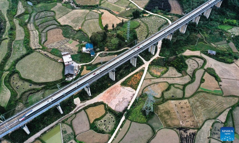 This aerial photo taken on Oct. 10, 2023 shows a bullet train running on a section of the Guiyang-Guangzhou high-speed railway in Duyun City, southwest China's Guizhou Province. In 2014, the Guiyang-Guangzhou High-speed Railway connecting Guiyang, capital of southwest China's Guizhou Province, and Guangzhou, capital of south China's Guangdong Province, went into operation.(Photo: Xinhua)