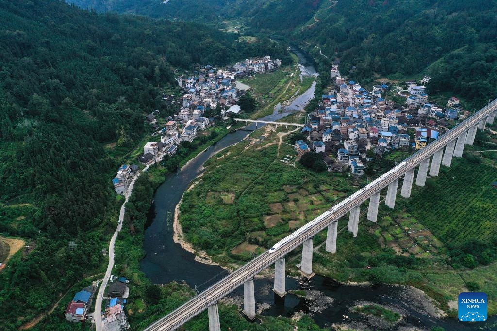 This aerial photo taken on Oct. 10, 2023 shows a bullet train running on a section of the Guiyang-Guangzhou high-speed railway in Congjiang County, southwest China's Guizhou Province. In 2014, the Guiyang-Guangzhou High-speed Railway connecting Guiyang, capital of southwest China's Guizhou Province, and Guangzhou, capital of south China's Guangdong Province, went into operation.(Photo: Xinhua)