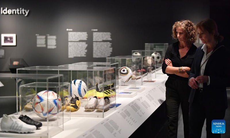 A staff member introduces exhibits during the press preview for the new exhibition Designing the Beautiful Game at the FIFA Museum in Zurich, Switzerland, Oct. 12, 2023. The FIFA Museum in Zurich presents the exhibition Designing the Beautiful Game from Oct. 13, 2023. (Photo: Xinhua)